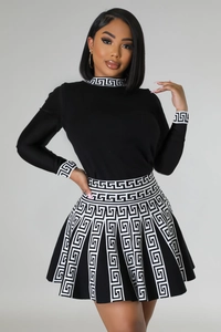 Detail shot of the Greek Meander pattern on the black knitted long sleeve dress