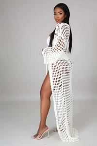 Detail of white hollow crochet beach cover-up with diamond mesh and side slit design