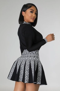 Detail view of knitted two-piece set featuring elegant Greek Key patterns on the cuffs and hem