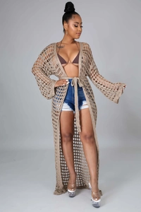 Detailed knit texture of long beige crochet cover up with elegant openwork pattern