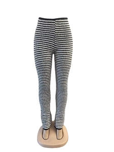 High waisted black and white striped flared knit trousers on a mannequin torso