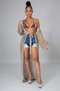 Detail of beige knit crochet cover up with large mesh hollow texture and waist tie