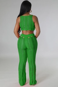Detail view of green knitted set featuring a distressed ladder cut-out texture on the back