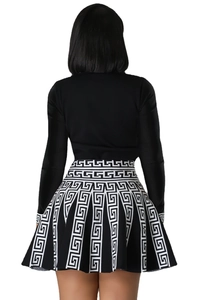 Back view of a long sleeve black top and a high-waisted Greek Key print pleated mini skirt