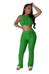 Detail of green knit two-piece set featuring cutout textures and sleeveless cropped design