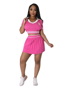 Close-up of pink knitted crop top with B embroidery and pleated mini skirt set