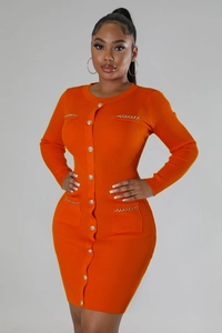 Detail of orange ribbed knit dress featuring gold buttons and metallic chain pockets