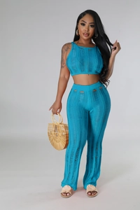 Detail of teal knit two-piece set featuring cutout sleeveless crop top and trousers
