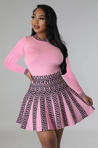Detail of pink knit two-piece set featuring black Greek key patterns on hems and waist