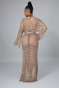 Detail of beige knit beach cover-up featuring openwork crochet patterns and matching belt