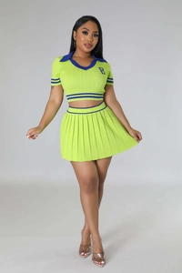 Detail of lime green ribbed knit polo top and pleated skirt with blue stripes