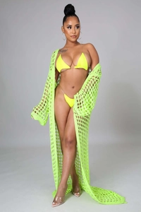Close-up of lime green crochet knit fabric texture on the beach cover-up maxi dress