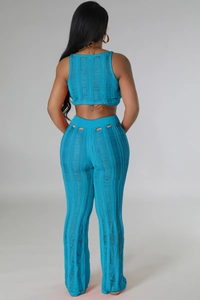 Macro detail of the blue knit two-piece set featuring distressed holes and hollow texture