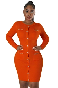 Detail of orange ribbed knit mini dress with gold buttons and metal chain accents