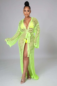 Detailed close-up of neon yellow crochet knit texture on a long beach cover-up robe