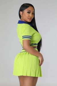 Detail of neon green ribbed knit two-piece set featuring navy blue striped trim on polo collar