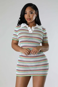 Detailed close-up of the crochet knit texture and colorful stripes on the white dress