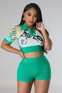 Detail of green knitted set featuring abstract portrait print and rhinestone buttons