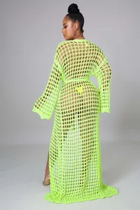 Detail of neon green open knit fabric and drawstring waist on long beach cover-up