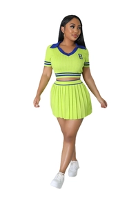 Detail of knitted crop top and pleated skirt set with blue stripe and B embroidery