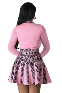 Detailed back view of a pink knit two-piece set with a Greek Key pattern and pleated skirt