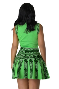 Back view of green knit two-piece set featuring pleated skirt and black Greca patterns