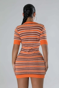 Rear view of slim fit knit mini dress featuring retro orange and brown horizontal stripes