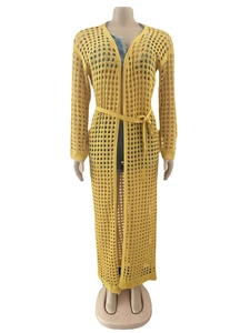 Detail of ginger yellow crochet knit cover up featuring openwork mesh and matching waist belt
