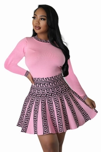 Detailed view of pink knitted two-piece set featuring black Greek meander patterns