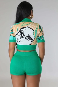 Detail view of the green knitted two-piece set featuring back anime girl graphic