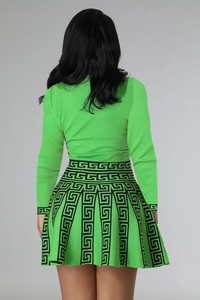 Detail of lime green knit top and A-line skirt with black Greek Key jacquard pattern