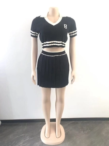 Close-up of black knit sports set with white 'B' embroidery and striped ribbing details
