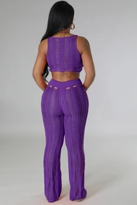 Detail of purple knitted two-piece set featuring hollow-out textures and a backless design