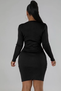 Detail of slim fit black ribbed knit dress showing the textured fabric and back silhouette