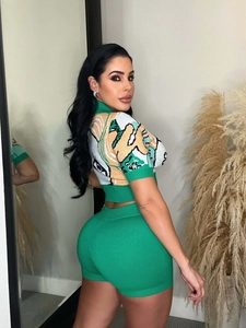 Detail of green knit two-piece set featuring jacquard cropped top and high waist shorts