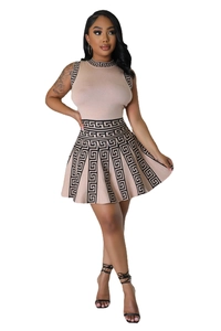 Detail of knit sleeveless top and pleated skirt with Greek key geometric patterns
