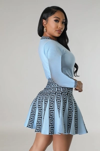 Side view of blue knitted long sleeve dress set with Greek key patterns and pleated skirt