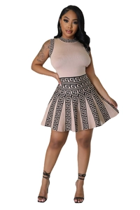 Close-up of pink knit two-piece set with black Greek key pattern on neckline and hem