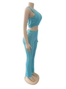 Detail of light blue knit set showing vertical texture and waist cut-out on trousers