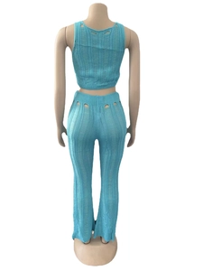 Macro detail of sky blue knit two-piece set featuring cutout back and hollow texture