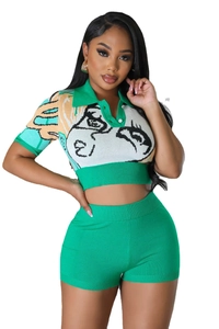 Detail of green knitted two-piece set featuring abstract portrait pattern and polo collar