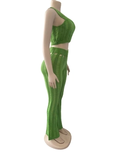 Detail view of grass green knit set with ribbed texture and chic distressed hollow out design