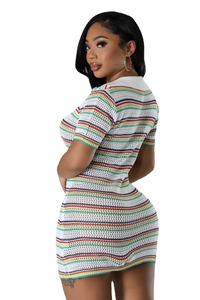 Detailed view of white knit mini dress featuring colorful horizontal stripes and texture