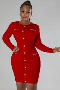 Detail of red ribbed knit dress featuring gold metal buttons and chain pocket accents