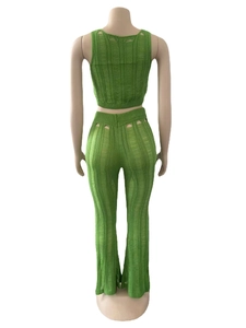 Macro shot of green hollow out knit texture on back of sleeveless crop top and trousers