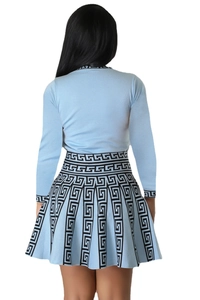 Rear view of light blue knitted two-piece set with black Greca pattern on cuffs and hem