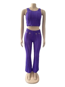Detailed close-up of purple knitted two-piece set featuring hollow-out vertical patterns