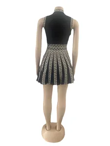 Detail of Greek fret pattern on black sleeveless pleated dress back view on mannequin