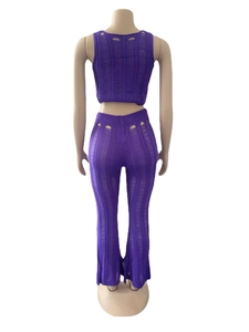 Rear view of purple knit two-piece set featuring hollow-out tank top and flared pants