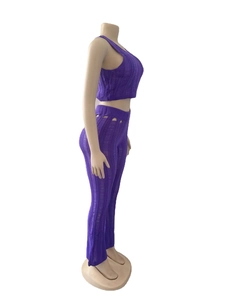 Detail of purple ribbed knit set showing hollow-out texture on sleeveless crop top and pants